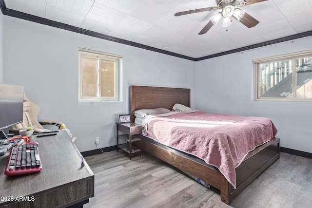 bedroom featuring a ceiling fan, baseboards, ornamental molding, and wood finished floors