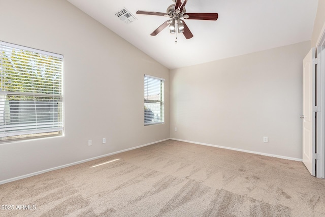 unfurnished room featuring light carpet, ceiling fan, and vaulted ceiling