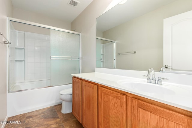 full bathroom with vanity, combined bath / shower with glass door, and toilet