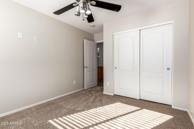 unfurnished bedroom featuring ceiling fan, a closet, and carpet floors