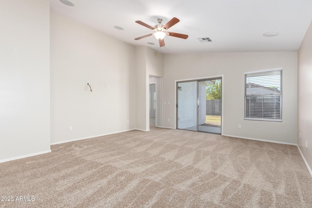 carpeted empty room featuring ceiling fan and lofted ceiling