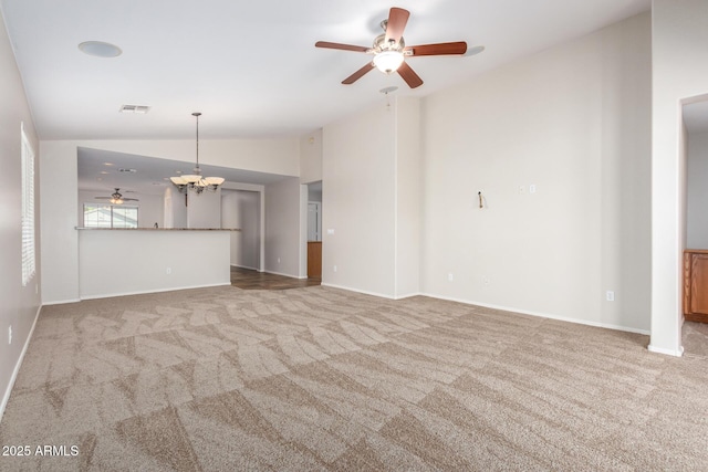 unfurnished living room with carpet, ceiling fan with notable chandelier, and lofted ceiling