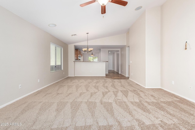 interior space featuring ceiling fan with notable chandelier, light colored carpet, and lofted ceiling