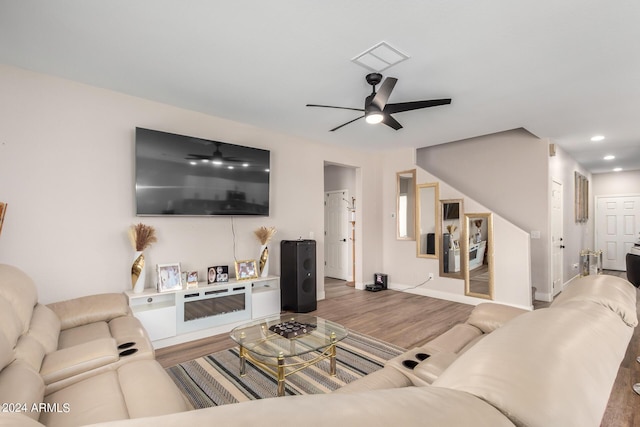 living room with ceiling fan and wood-type flooring