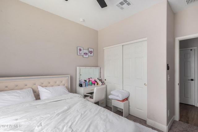 carpeted bedroom featuring ceiling fan and a closet