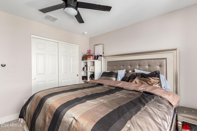 carpeted bedroom featuring ceiling fan and a closet