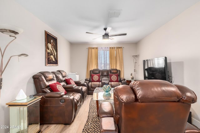 living room featuring ceiling fan and light hardwood / wood-style flooring