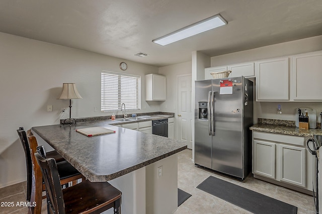 2125 W Central Ave, Coolidge, AZ 85128 - kitchen with stainless steel refrigerator with ice dispenser, dishwasher, a peninsula, dark countertops, and a kitchen breakfast bar