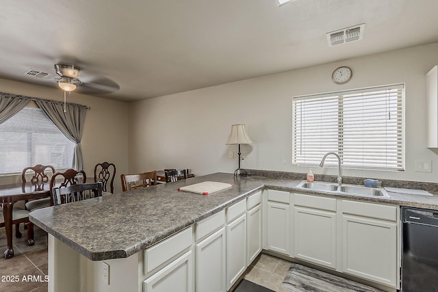2125 W Central Ave, Coolidge, AZ 85128 - kitchen featuring dishwasher, light tile patterned floors, a peninsula, a ceiling fan, and white cabinetry