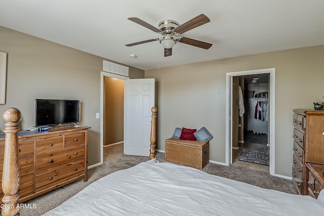 2125 W Central Ave, Coolidge, AZ 85128 - carpeted bedroom featuring a walk in closet, a ceiling fan, and a closet