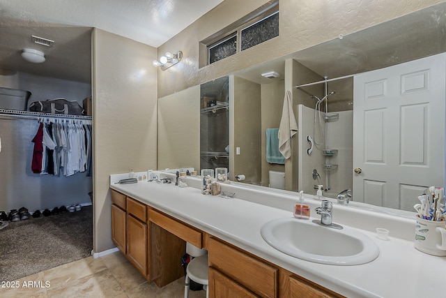 2125 W Central Ave, Coolidge, AZ 85128 - full bath featuring double vanity, a walk in closet, and tile patterned flooring