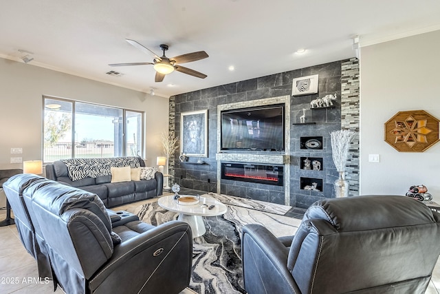 tiled living room featuring a tile fireplace, tile walls, ceiling fan, and crown molding