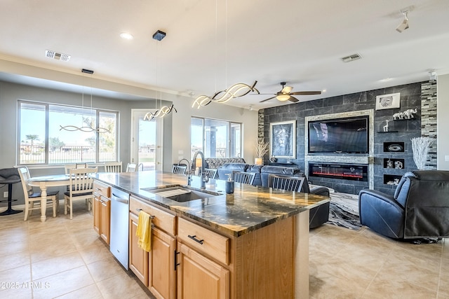 kitchen with pendant lighting, sink, a center island with sink, and plenty of natural light