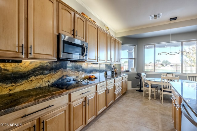 kitchen featuring light tile patterned flooring, ornamental molding, appliances with stainless steel finishes, dark stone counters, and decorative backsplash