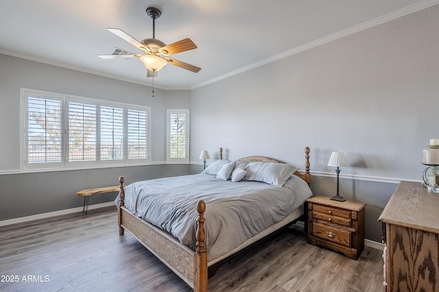 bedroom featuring crown molding, ceiling fan, and wood-type flooring