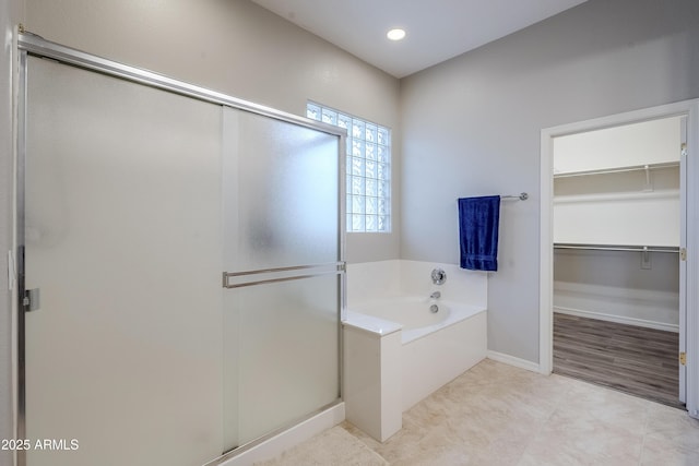 bathroom featuring independent shower and bath