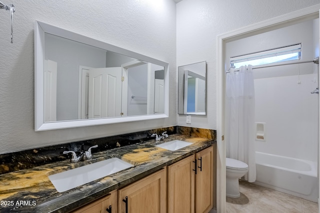 full bathroom featuring vanity, shower / tub combo, and toilet