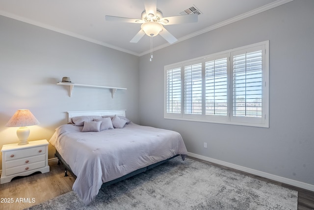 bedroom with hardwood / wood-style floors, crown molding, and ceiling fan