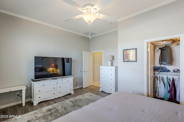 bedroom featuring wood-type flooring, ornamental molding, a closet, and ceiling fan