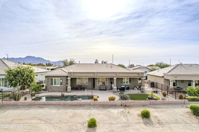 rear view of house with a patio and a mountain view