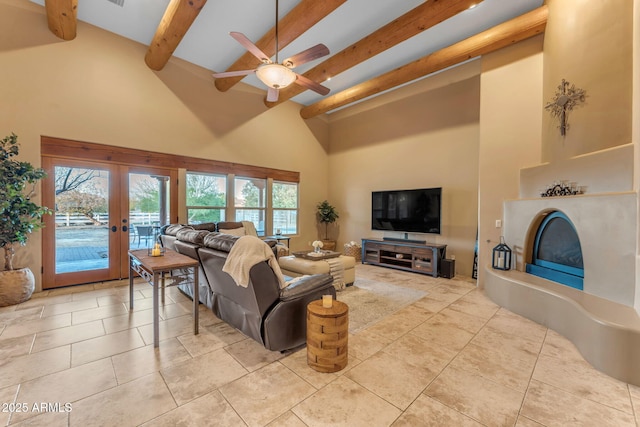 living room with ceiling fan, light tile patterned flooring, a towering ceiling, french doors, and beamed ceiling