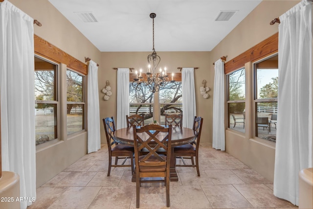 dining room featuring light tile patterned floors and a chandelier