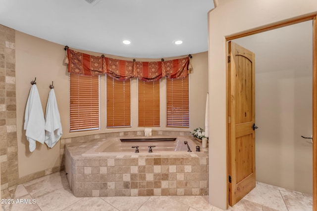 bathroom featuring a relaxing tiled tub