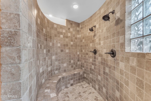 bathroom with tiled shower