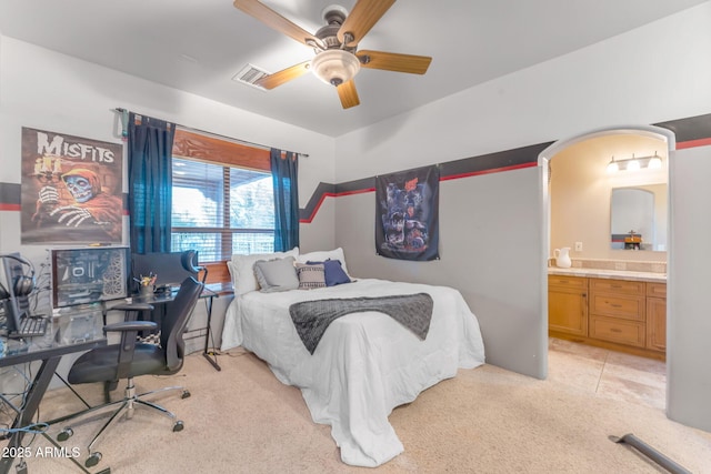 carpeted bedroom featuring ceiling fan and connected bathroom