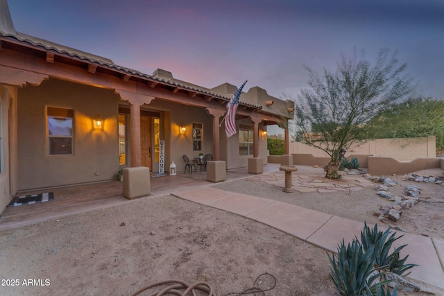 view of patio terrace at dusk