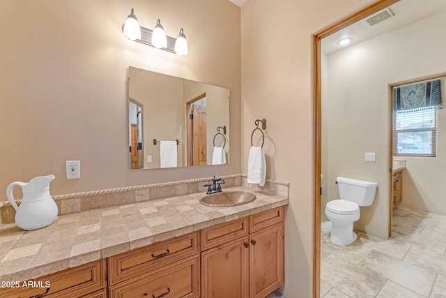 bathroom featuring toilet and vanity