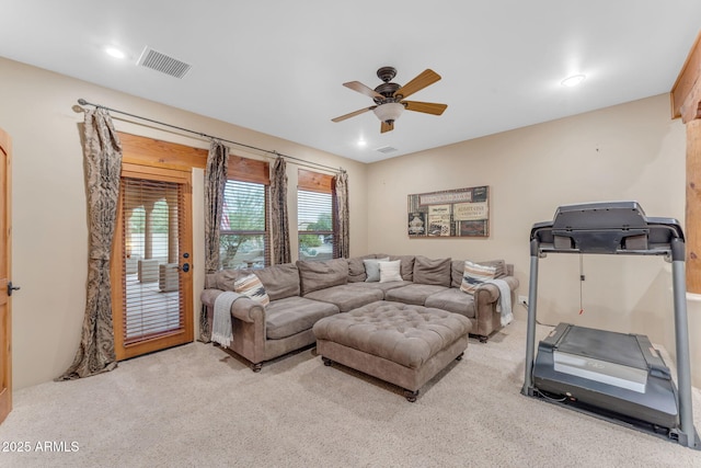 carpeted living room featuring ceiling fan