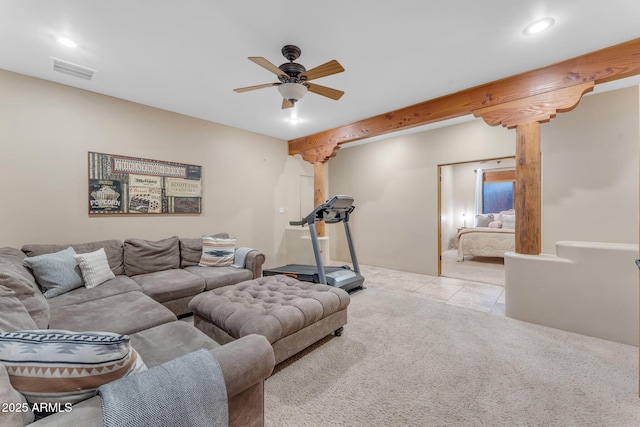 living room with ceiling fan, beam ceiling, and light colored carpet