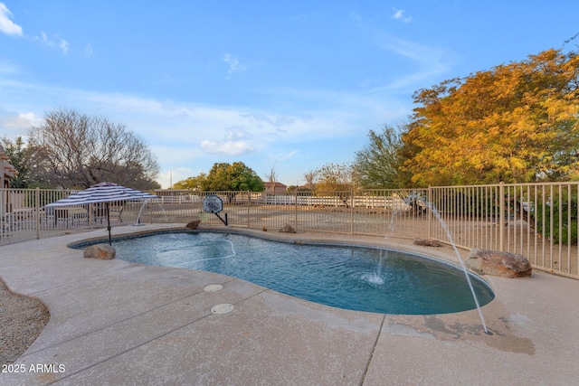 view of swimming pool with pool water feature and a patio