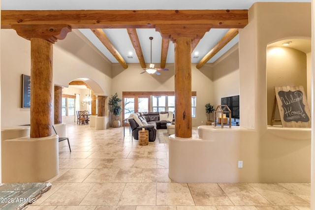 living room with ceiling fan, beam ceiling, and decorative columns