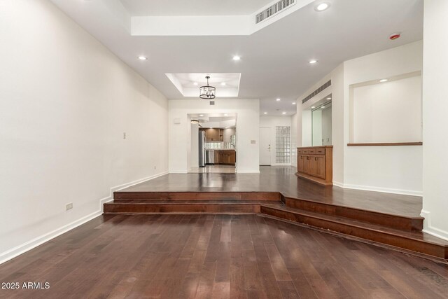 902 W Glendale Ave Unit 102, Phoenix, AZ 85021 - hall featuring a tray ceiling, hardwood / wood-style flooring, baseboards, and recessed lighting