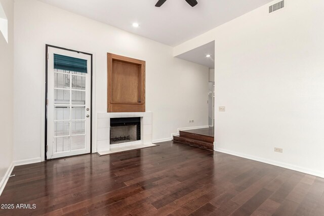 902 W Glendale Ave Unit 102, Phoenix, AZ 85021 - unfurnished living room featuring wood finished floors, ceiling fan, a tiled fireplace, baseboards, and recessed lighting