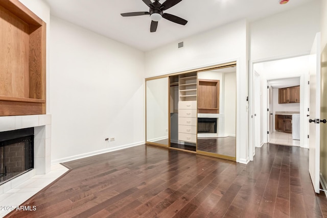902 W Glendale Ave Unit 102, Phoenix, AZ 85021 - unfurnished living room with a tiled fireplace, a ceiling fan, wood finished floors, and baseboards