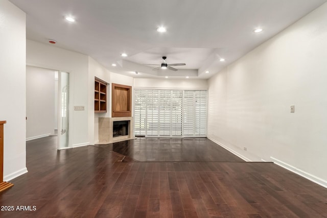 902 W Glendale Ave Unit 102, Phoenix, AZ 85021 - unfurnished living room featuring ceiling fan, baseboards, recessed lighting, dark wood-style floors, and a tile fireplace