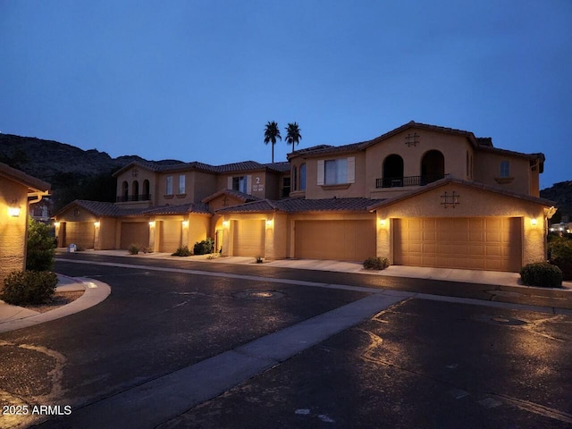 mediterranean / spanish house featuring a garage and a mountain view