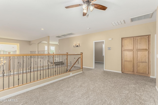 carpeted spare room with ceiling fan