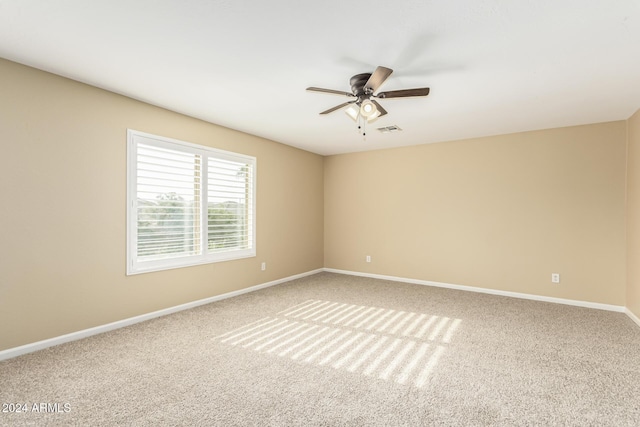 spare room featuring carpet and ceiling fan