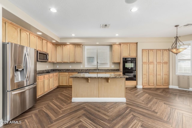 kitchen with dark parquet flooring, dark stone counters, light brown cabinetry, appliances with stainless steel finishes, and decorative light fixtures