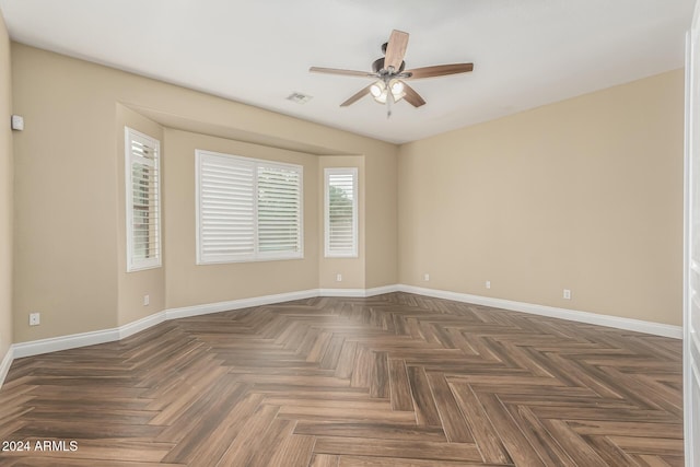 unfurnished room featuring dark parquet floors and ceiling fan