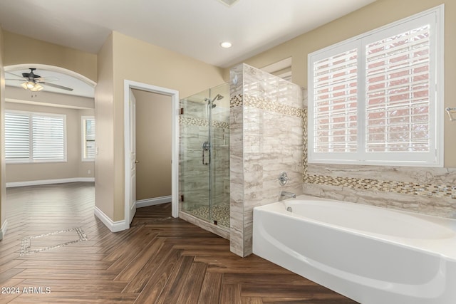 bathroom featuring parquet floors, shower with separate bathtub, and ceiling fan