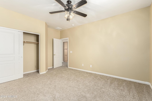 unfurnished bedroom with light carpet, a closet, and ceiling fan