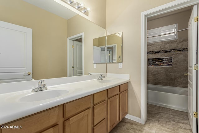 bathroom with vanity and tiled shower / bath