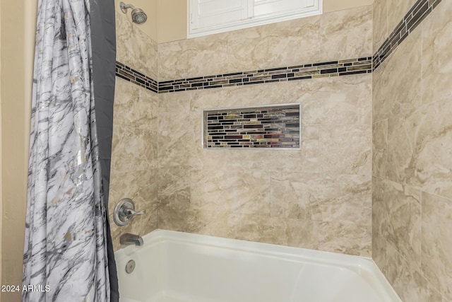 bathroom with shower / tub combo with curtain