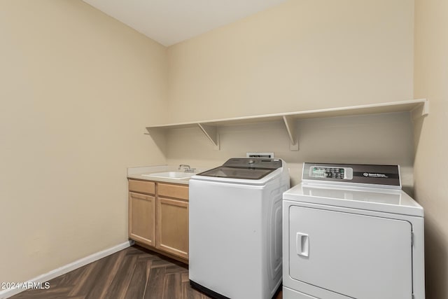 laundry area with dark parquet flooring, cabinets, sink, and washer and dryer