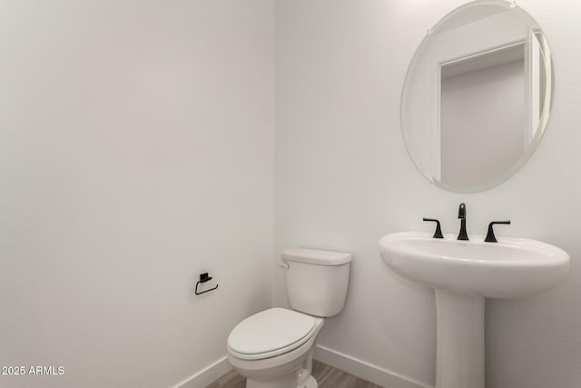 40563 W Michaels Dr, Maricopa, AZ 85138 - half bath featuring baseboards, toilet, and wood finished floors